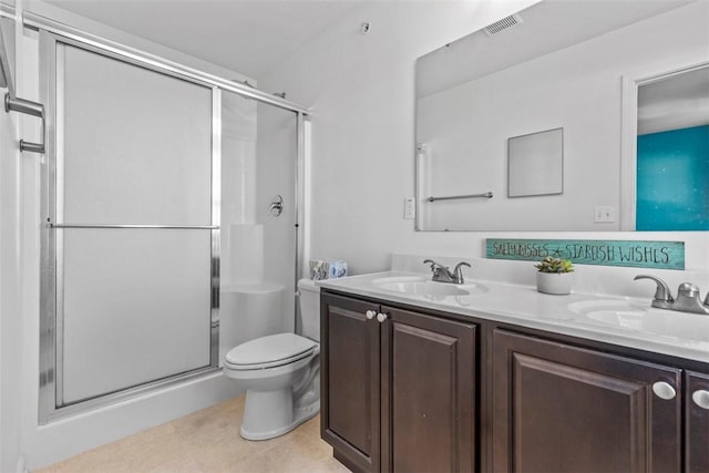 bathroom with vanity, tile patterned flooring, a shower with door, and toilet