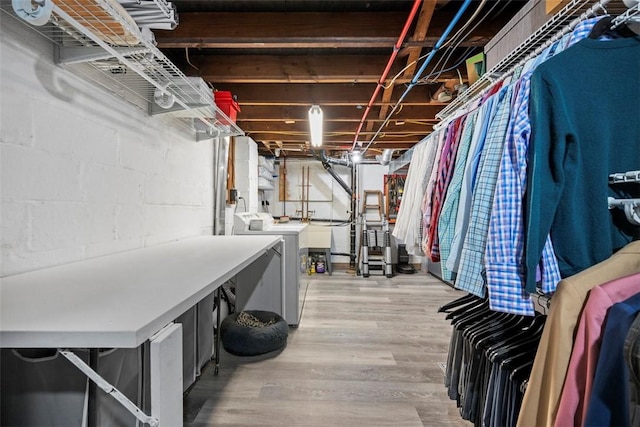 basement with washer and clothes dryer and wood-type flooring