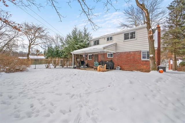 snow covered house with central AC