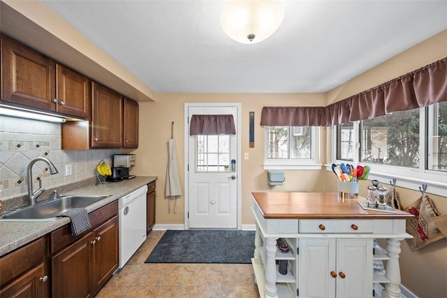 kitchen with dishwasher, tasteful backsplash, and sink