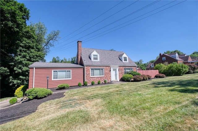 cape cod-style house featuring a front lawn