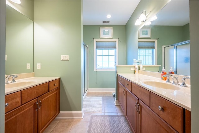 bathroom with vanity, tile patterned floors, and a shower with door