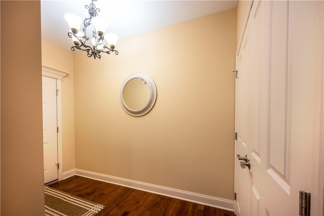 interior space with a notable chandelier and dark hardwood / wood-style floors