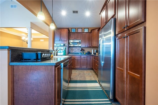 kitchen featuring pendant lighting, decorative backsplash, sink, appliances with stainless steel finishes, and decorative columns