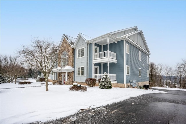 view of snowy exterior featuring a balcony