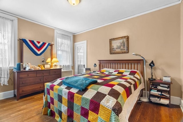 bedroom featuring ornamental molding and wood-type flooring