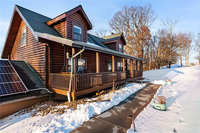 snow covered house with covered porch