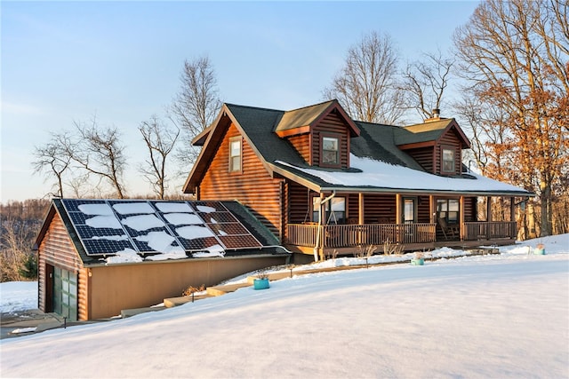 view of front of house featuring a garage, a porch, and solar panels