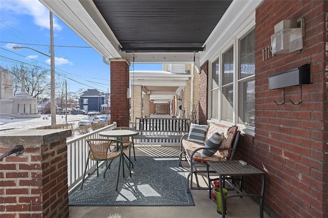 snow covered patio with covered porch