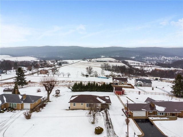 snowy aerial view featuring a mountain view