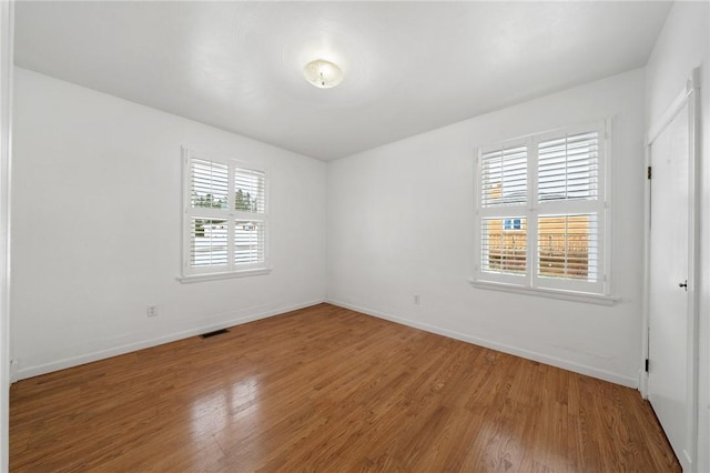 empty room featuring hardwood / wood-style flooring