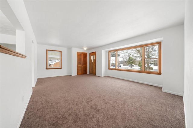 unfurnished living room featuring carpet floors