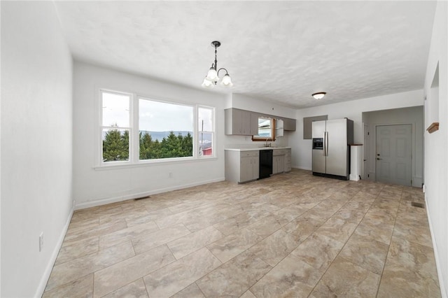 kitchen with gray cabinets, an inviting chandelier, dishwasher, stainless steel fridge, and a textured ceiling