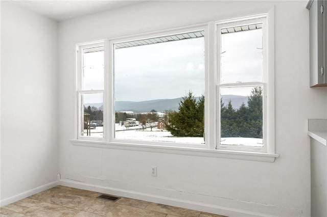 spare room with a mountain view