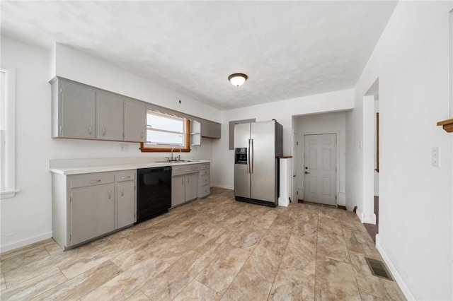 kitchen featuring sink, black dishwasher, stainless steel fridge with ice dispenser, and gray cabinetry