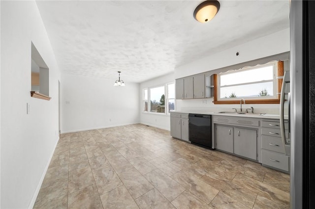 kitchen featuring sink, gray cabinetry, decorative light fixtures, stainless steel refrigerator, and black dishwasher