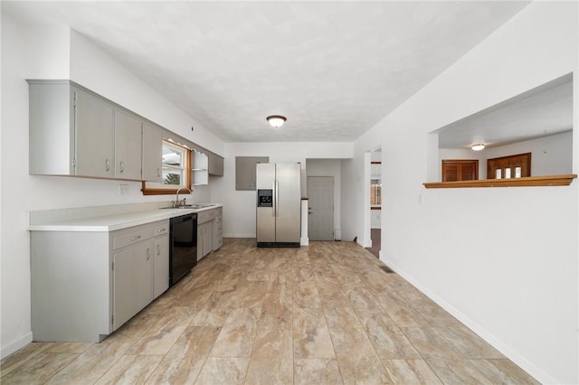 kitchen featuring gray cabinets, black dishwasher, sink, and stainless steel fridge with ice dispenser