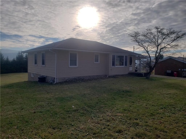 exterior space with a yard and central AC unit