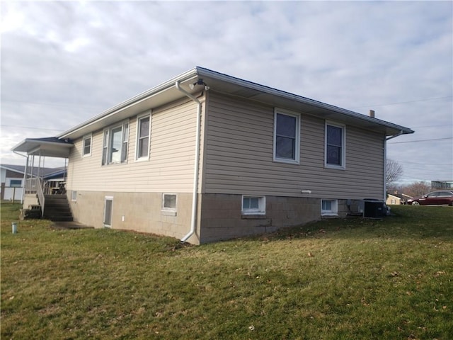 view of home's exterior with central AC and a lawn