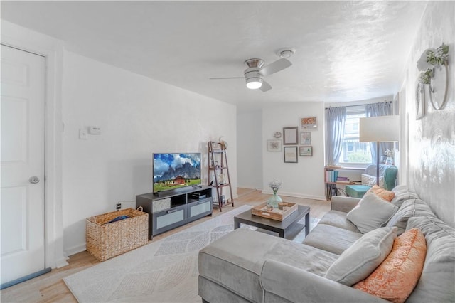 living room with ceiling fan and light hardwood / wood-style floors