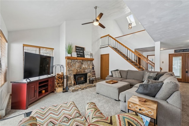 carpeted living room with ceiling fan, a skylight, french doors, and high vaulted ceiling