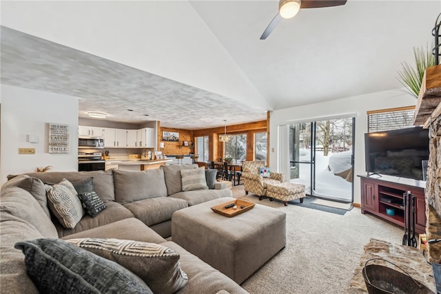 carpeted living room featuring ceiling fan and high vaulted ceiling