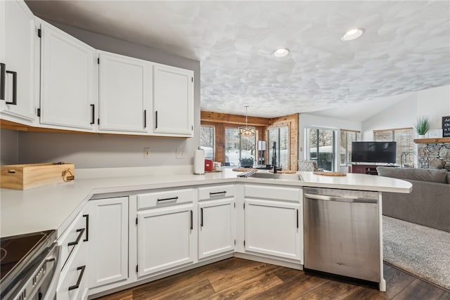 kitchen with white cabinetry, kitchen peninsula, appliances with stainless steel finishes, pendant lighting, and sink