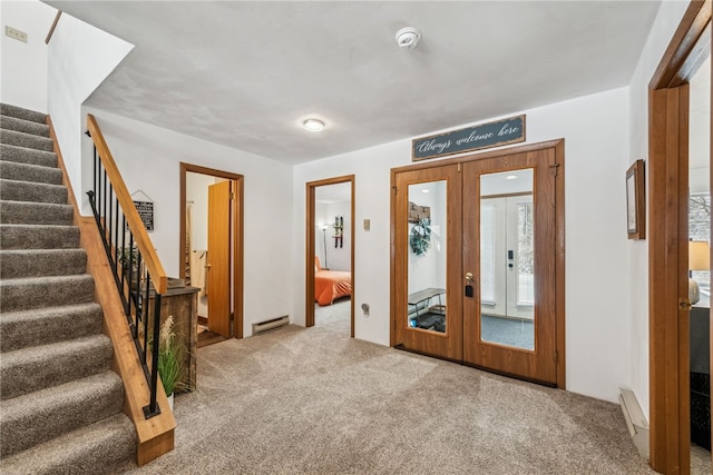 foyer entrance featuring carpet floors, french doors, and a baseboard radiator