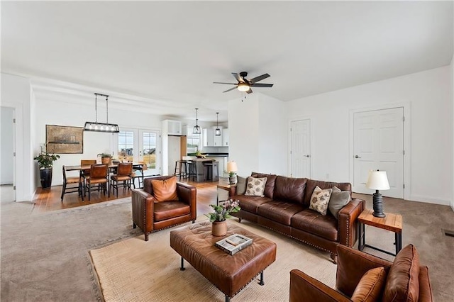 living room with ceiling fan and light carpet