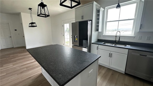 491 Shannon Dr, Mount Pleasant Twp Wml, PA 15666 - kitchen featuring appliances with stainless steel finishes, dark countertops, light wood-style flooring, and plenty of natural light