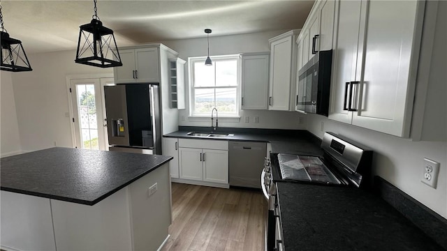 491 Shannon Dr, Mount Pleasant Twp Wml, PA 15666 - kitchen featuring stainless steel appliances, dark countertops, healthy amount of natural light, and light wood-type flooring