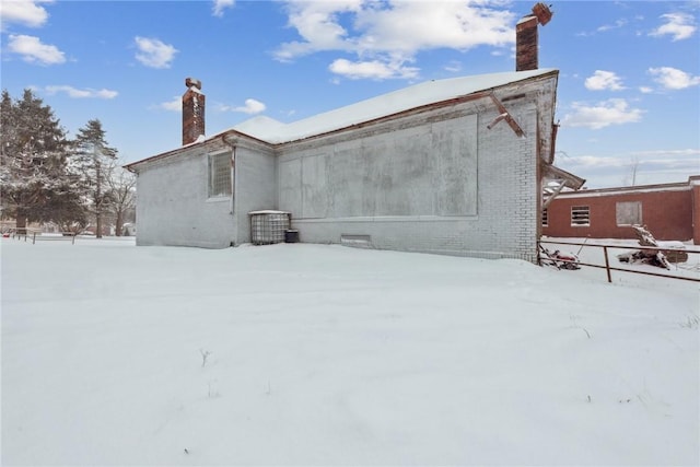 view of snow covered rear of property