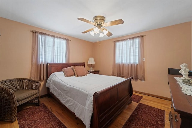 bedroom with ceiling fan and light hardwood / wood-style flooring