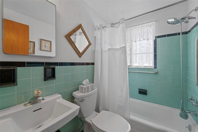 full bathroom with toilet, shower / tub combo, tile walls, and sink