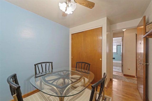 dining space featuring ceiling fan and light hardwood / wood-style flooring