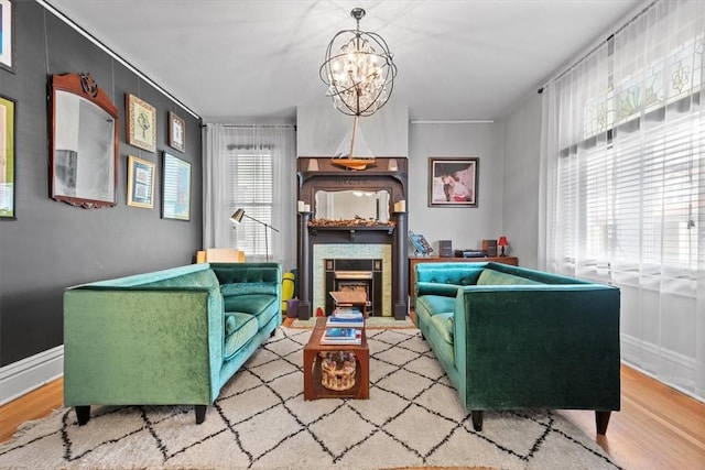 living area featuring light hardwood / wood-style floors and a notable chandelier