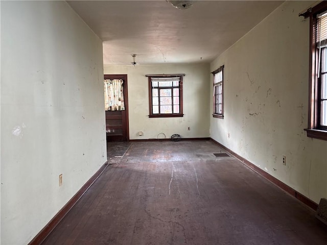 empty room with dark hardwood / wood-style floors