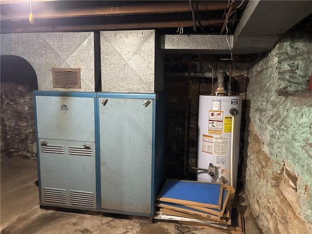 utility room featuring water heater