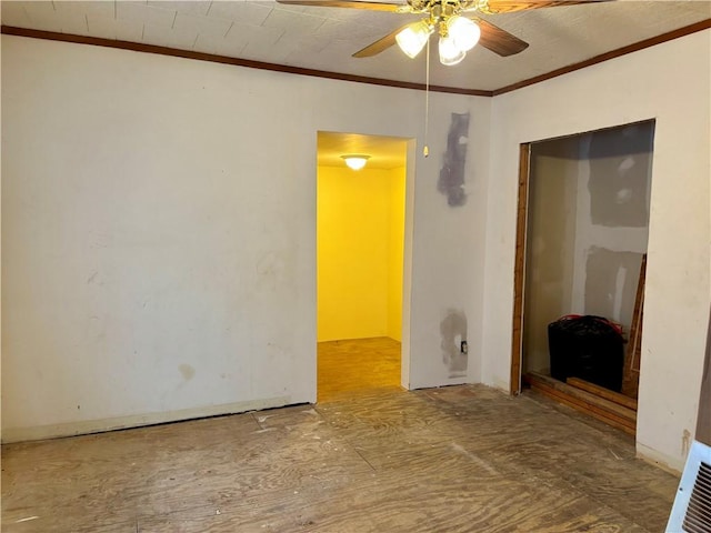 spare room featuring ceiling fan and crown molding