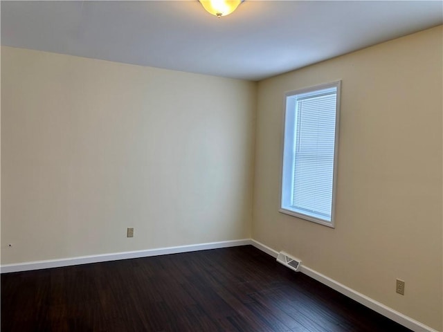 empty room with dark wood-type flooring