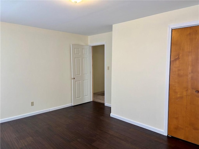 spare room with dark hardwood / wood-style floors