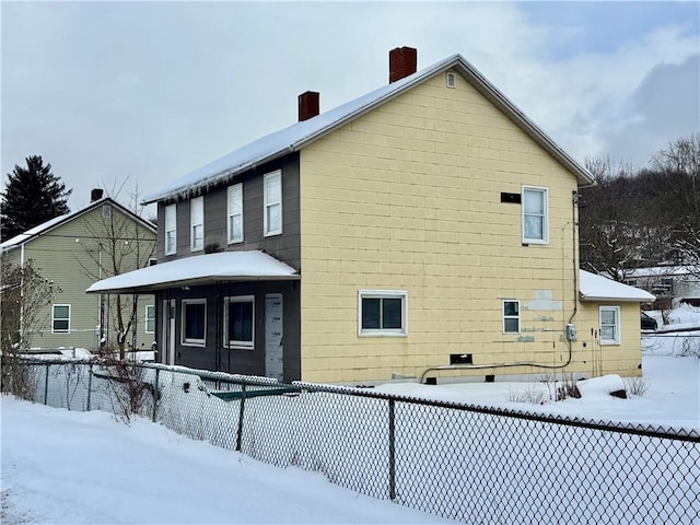 snow covered property with covered porch