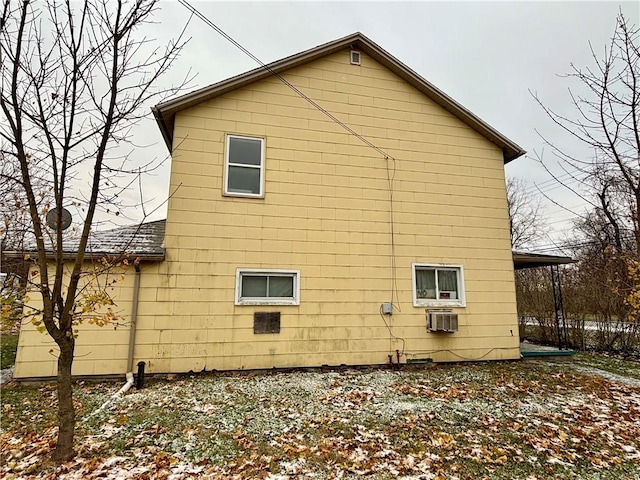 view of home's exterior with an AC wall unit