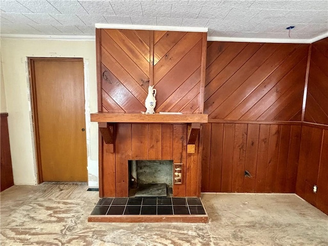 unfurnished living room with crown molding, wood walls, and carpet flooring