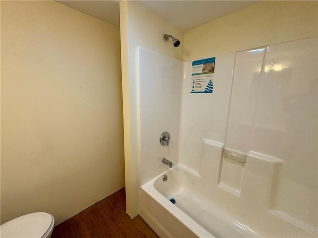 bathroom featuring shower / bathing tub combination, wood-type flooring, and toilet