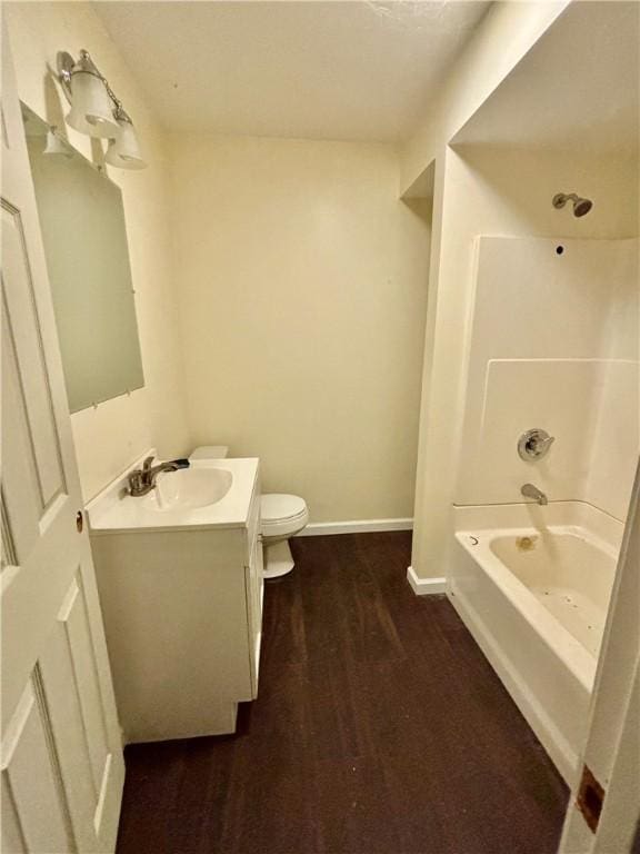 full bathroom with hardwood / wood-style flooring, toilet, vanity, and  shower combination