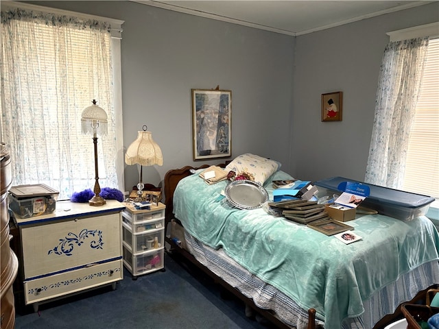 carpeted bedroom with crown molding