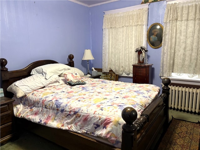 bedroom with radiator and crown molding