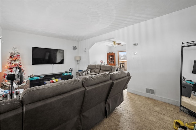 living room featuring ceiling fan and carpet