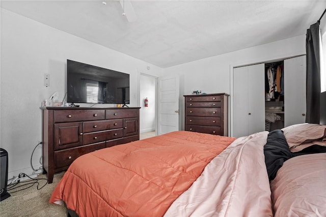 carpeted bedroom with a closet and a fireplace